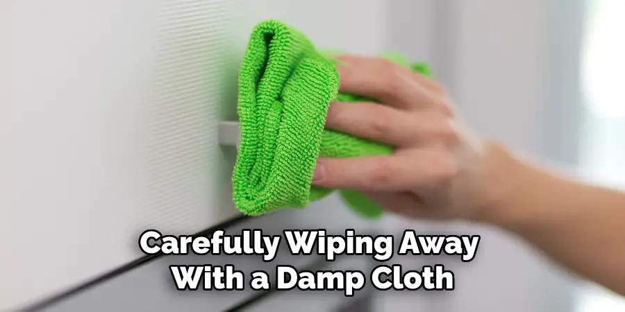 Carefully Wiping Away With a Damp Cloth