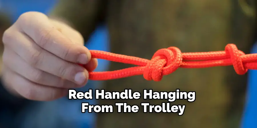 Red Handle Hanging From the Trolley