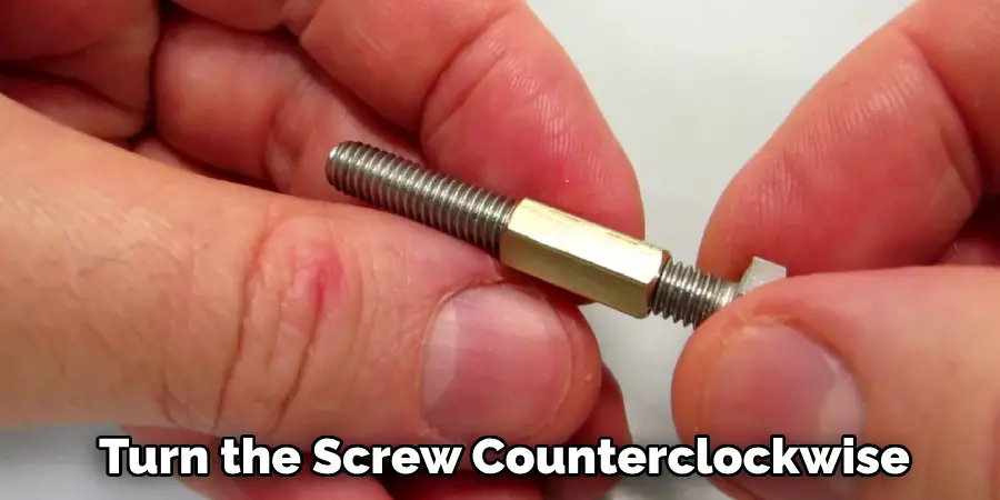 Turn the screw counterclockwise