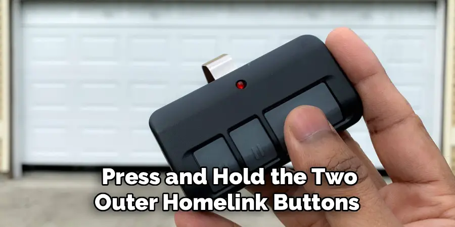 Press and Hold the Two
Outer Homelink Buttons 
